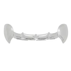 Detailed shot of trendy silver hip-hop vampire fangs grillz, sleek hollow tooth caps for party.