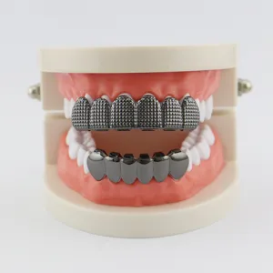 Close-up view of hip-hop grillz with textured grid top teeth and smooth bottom caps detail.