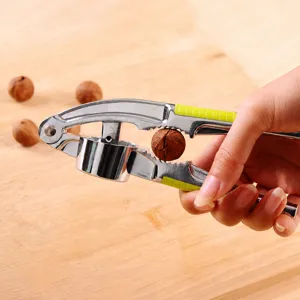 Manual zinc alloy garlic press and nut cracker with non-slip handle for kitchen use.