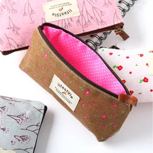 Detailed view of canvas pencil pouch with floral pattern and smooth zipper closure.