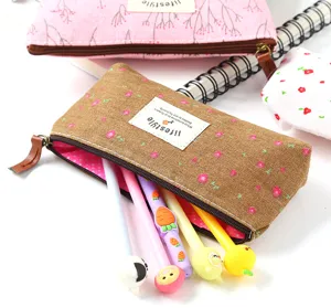 Floral canvas pencil case with cute pens, portable zipper stationery bag for school.