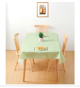 Close-up detail of the fresh green checkered tablecloth showcasing waterproof PVC material texture.