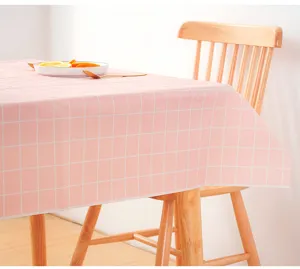 Pink grid PVC tablecloth detail showing fresh Nordic dining table setup and waterproof surface.