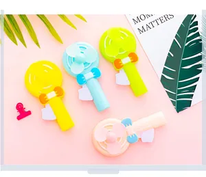 Detail view of cute cartoon hand press fan, mini portable plastic toy fan for children and kids.