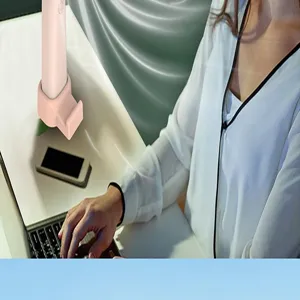 Detailed view of a portable mini handheld USB rechargeable fan with a phone stand base on desk.