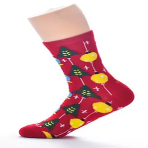 Christmas mid-calf socks for women featuring festive tree and yellow ball prints, soft cotton material.