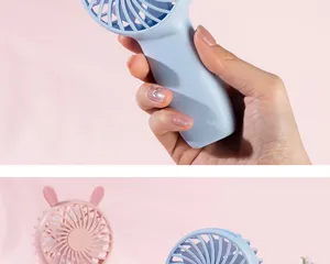 Close-up detail shot of the portable mini handheld USB rechargeable fan held in hand.