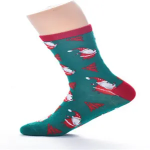 Close-up detail of women's mid-tube Christmas socks featuring cute Santa Claus and tree motifs.