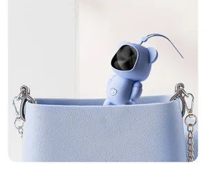 Portable USB rechargeable hand warmer, cute blue bear astronaut design detail view close up