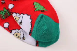 Detailed view of women's red Christmas socks featuring cute Santa and tree knit patterns.