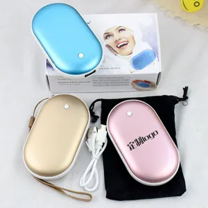 Details of the portable pebble USB rechargeable hand warmer and power bank in winter.