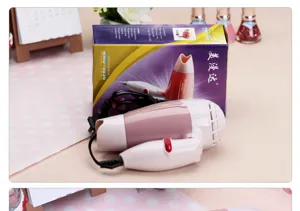 Compact foldable hair dryer in charming pink for daily use and travel convenience.