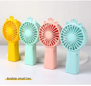 Detailed shot of colorful handheld mini fans with crown and cat ear design, portable electric fans.