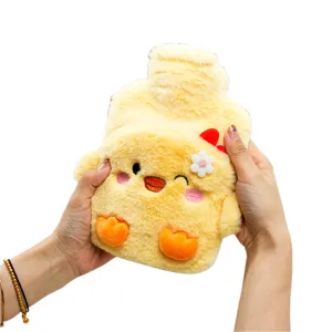 Cute yellow duck plush hot water bag held in hands, soft removable cover for winter warmth.