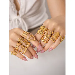Detailed view of multi-style gold stainless steel stackable rings with delicate open designs.