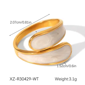 Detail view of minimalist gold titanium steel ring with white oil drop design, size and weight specs.