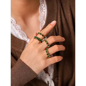 Stackable gold rings featuring vibrant green zircon stones in various chic shapes for women.