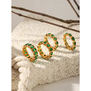 Green zirconia gold rings detail view, fashion stainless steel stackable jewelry set.
