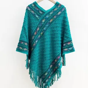 Detailed view of retro ethnic knit poncho, V-neck design and chic fringe hem style.
