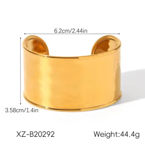 Wide gold stainless steel cuff bracelet with hammered texture, chunky statement open bangle.