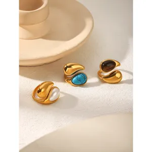 Stainless steel teardrop open rings set featuring turquoise, pearl and tiger eye stones.