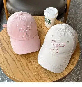 Detail shot of sweet bow embroidered baseball cap in pink and beige, perfect for cute daily looks.
