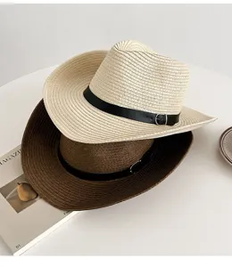Detail view of summer straw cowboy hat with leather band, sun protection beach sunhat.