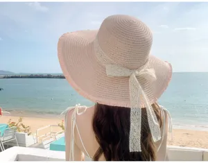 Women summer wide brim straw sun hat with lace bow, perfect for beach travel and outdoor protection.