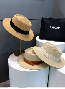 Summer straw hat detail view, featuring woven texture and elegant ribbon decoration. Perfect chic style.