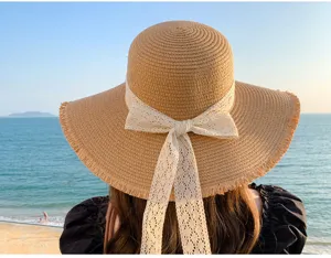 Detailed view of women's summer straw hat with lace bow, outdoor beach and travel style.