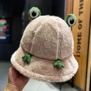 Plush frog bucket hat detail view, soft autumn winter warm fuzzy cap with cute cartoon eyes.