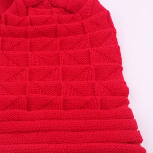 Red knit beanie detail showing waffle texture and folded brim for winter outdoor warmth.