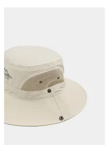 Closeup detail of beige outdoor bucket hat with breathable mesh and metal snap buttons.
