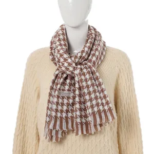 Brown and white houndstooth cashmere feel winter scarf detail close up view soft fringe design.