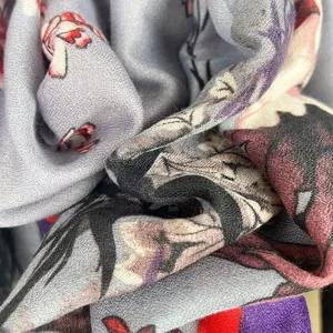 Close-up detail of soft cotton linen vintage art print scarf fabric with elegant folds.