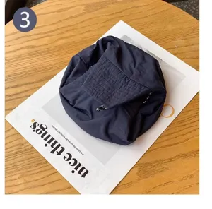Folded waterproof bucket hat detail, lightweight quick-dry fabric for outdoor travel.