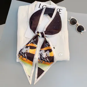 Detail view of narrow twilly scarf with starry sky and mecha horse pattern, chic long ribbon.