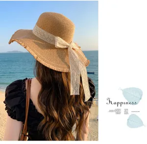 Detailed view of the stylish summer straw hat featuring an elegant lace bow and wide brim for beach.