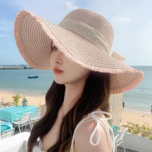 Women summer wide brim straw hat with bow, stylish beach sun protection hat for outdoor travel.