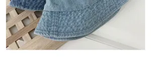 Close up detail of light blue denim bucket hat showing neat stitching and soft fabric texture.