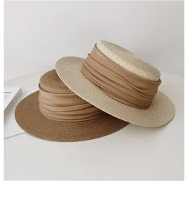 French style flat top straw hat with brown gathered fabric band, elegant summer sun protection.