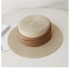 French flat top straw hat detail view, summer sun protection women's woven sun hat leisure style.