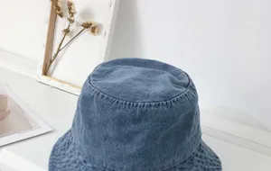 Korean style blue denim bucket hat, soft washed fabric, wide brim sun protection detail.