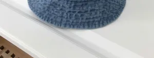 Close up view of blue denim bucket hat, wide brim sun protection hat, casual daily wear.