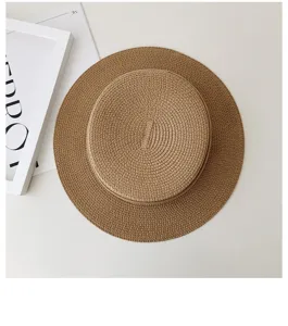 Detail view of a French flat-top straw hat in brown straw, perfect for summer sun protection.