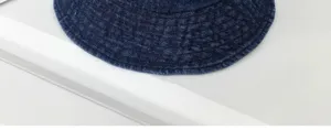 Detailed view of the dark blue denim bucket hat, stylish wide brim design for daily sun protection.