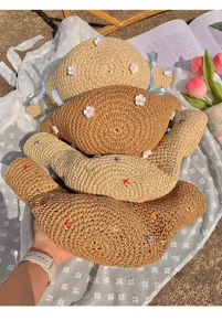 Woven straw sun hat with blue bow and floral decor for women beach vacation summer.