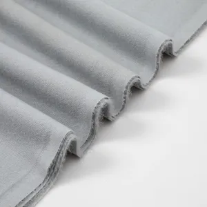 Grey cashmere-feel scarf fabric detail, soft brushed texture showing elegant folds