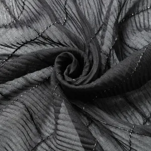 Black crinkled scarf detail view, shimmering silver thread grid fabric texture close-up.