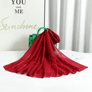 Detail view of the red pleated solid color long scarf with shiny silver wire texture for women.